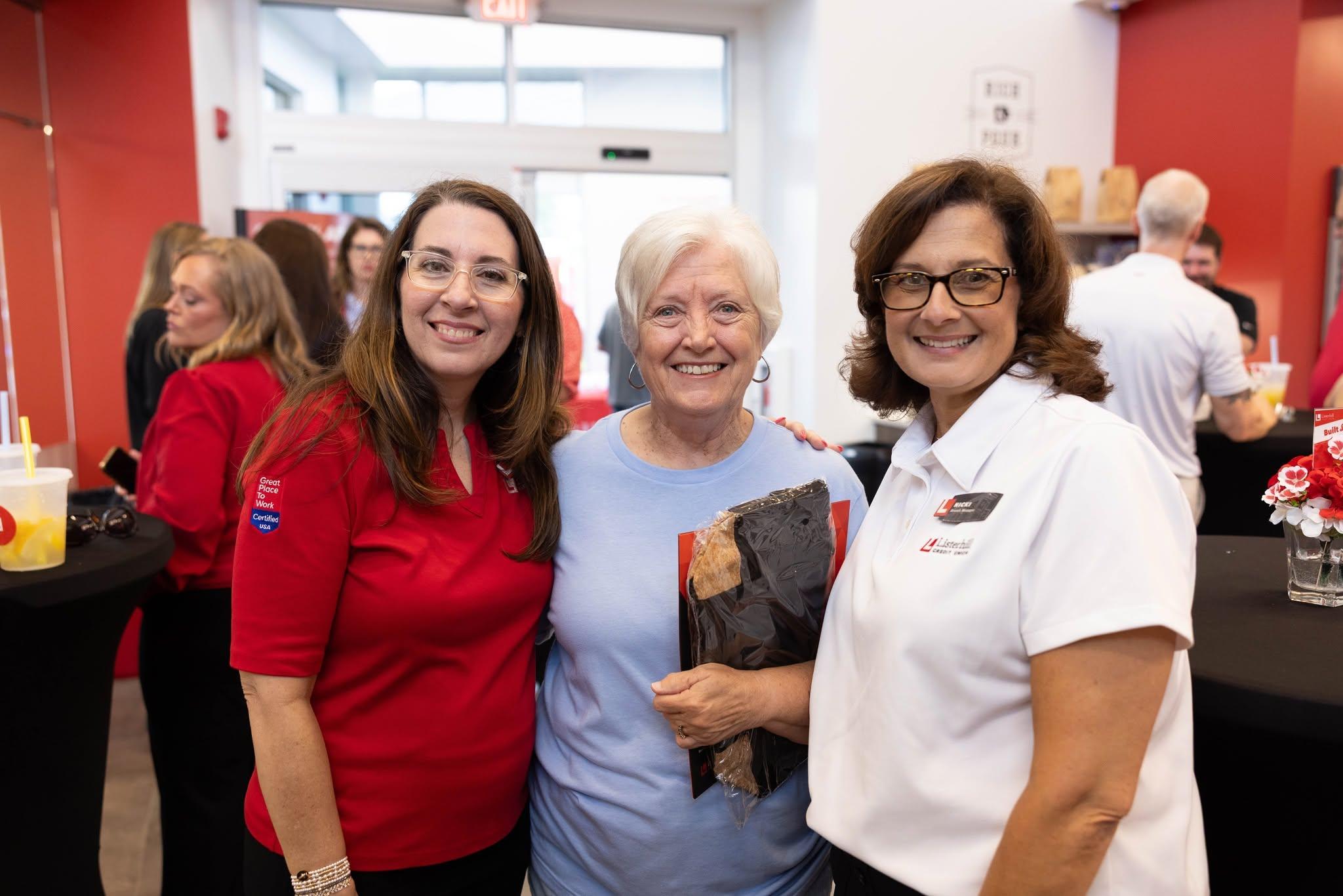 Listerhill employees pose for a photo with a Winfield member inside the new branch facility.