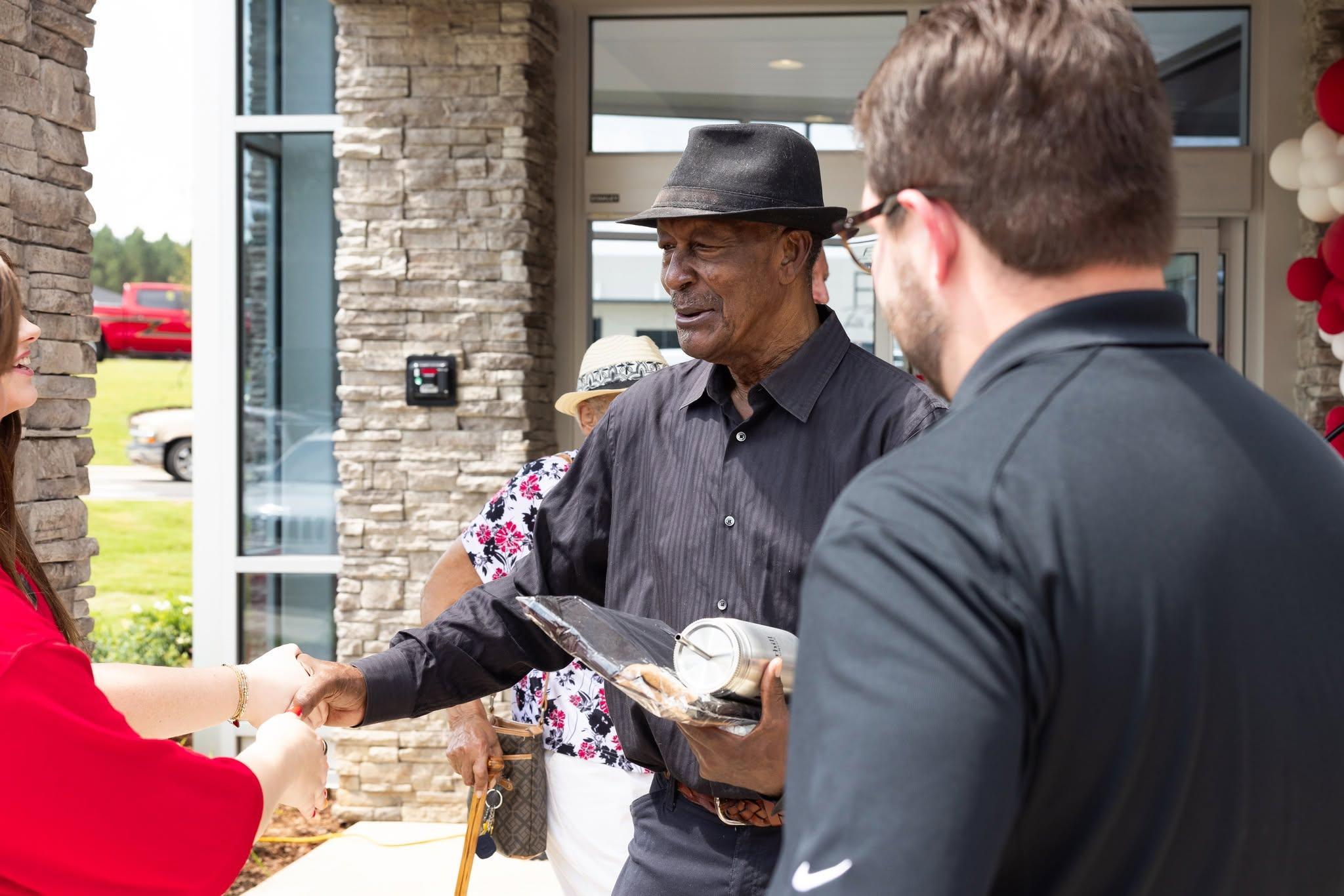 Listerhill employees shake hands with Winfield members as they celebrate the new branch's official opening.