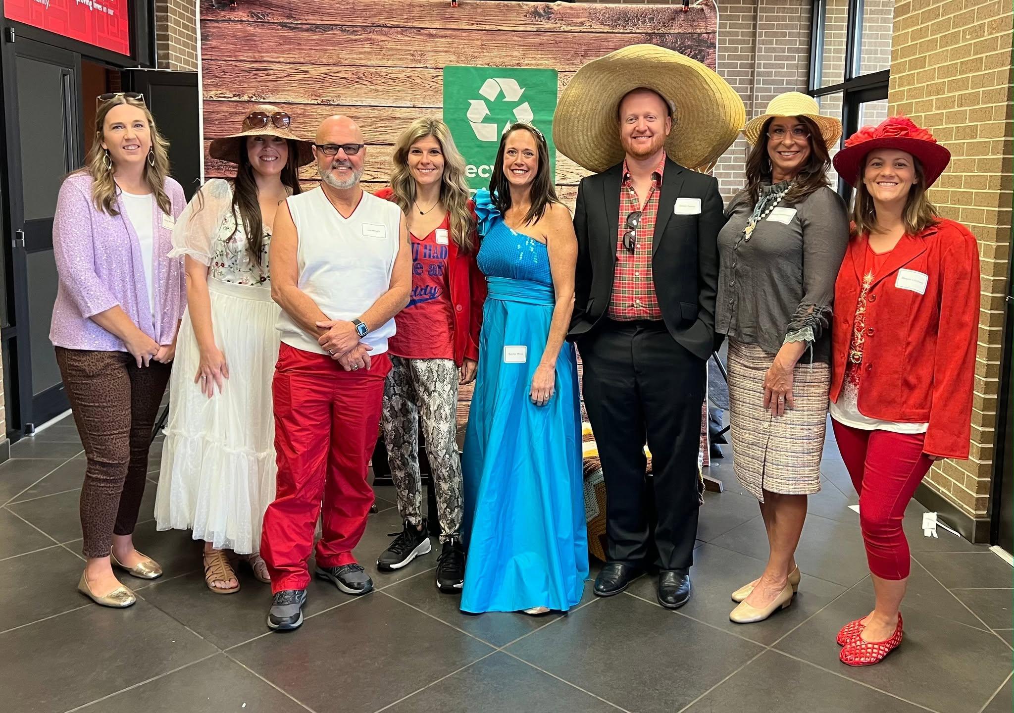 Employees pose together in themed attire during the Annual Employee Event.