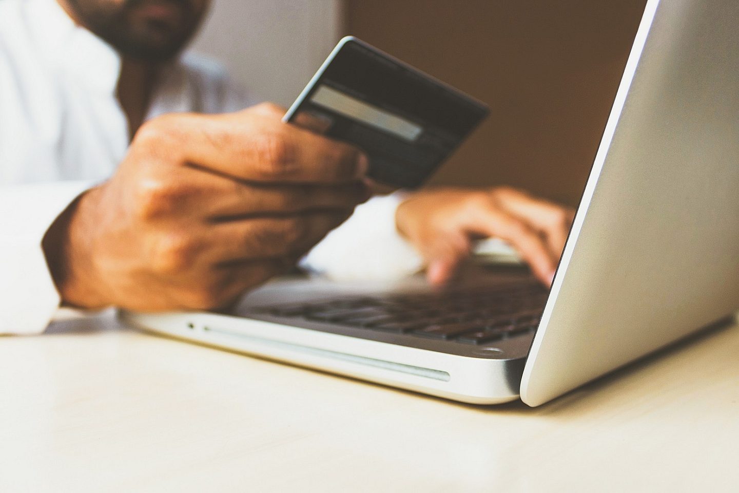 Man Holding Black Credit Card