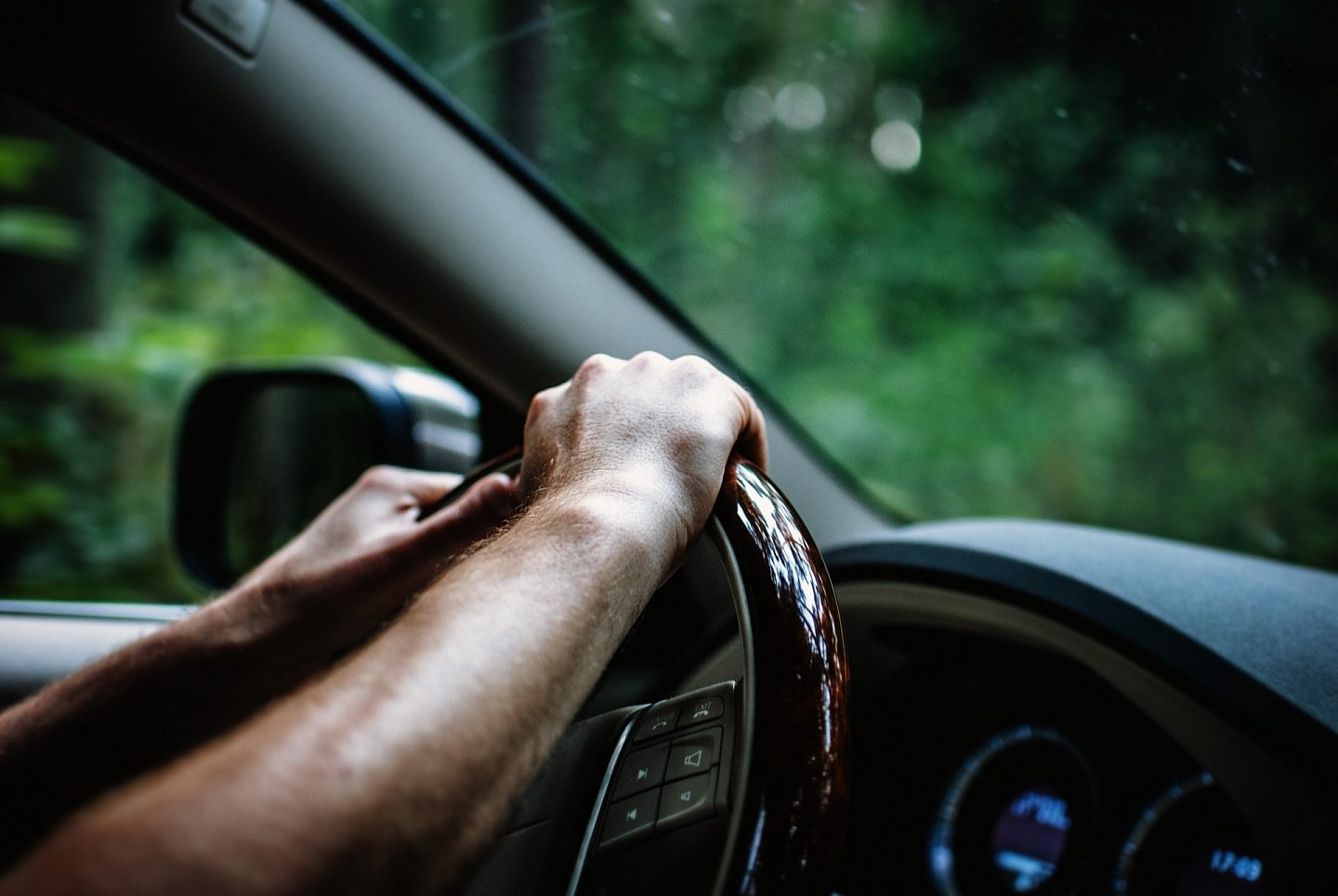 Man Holding Steering Wheel
